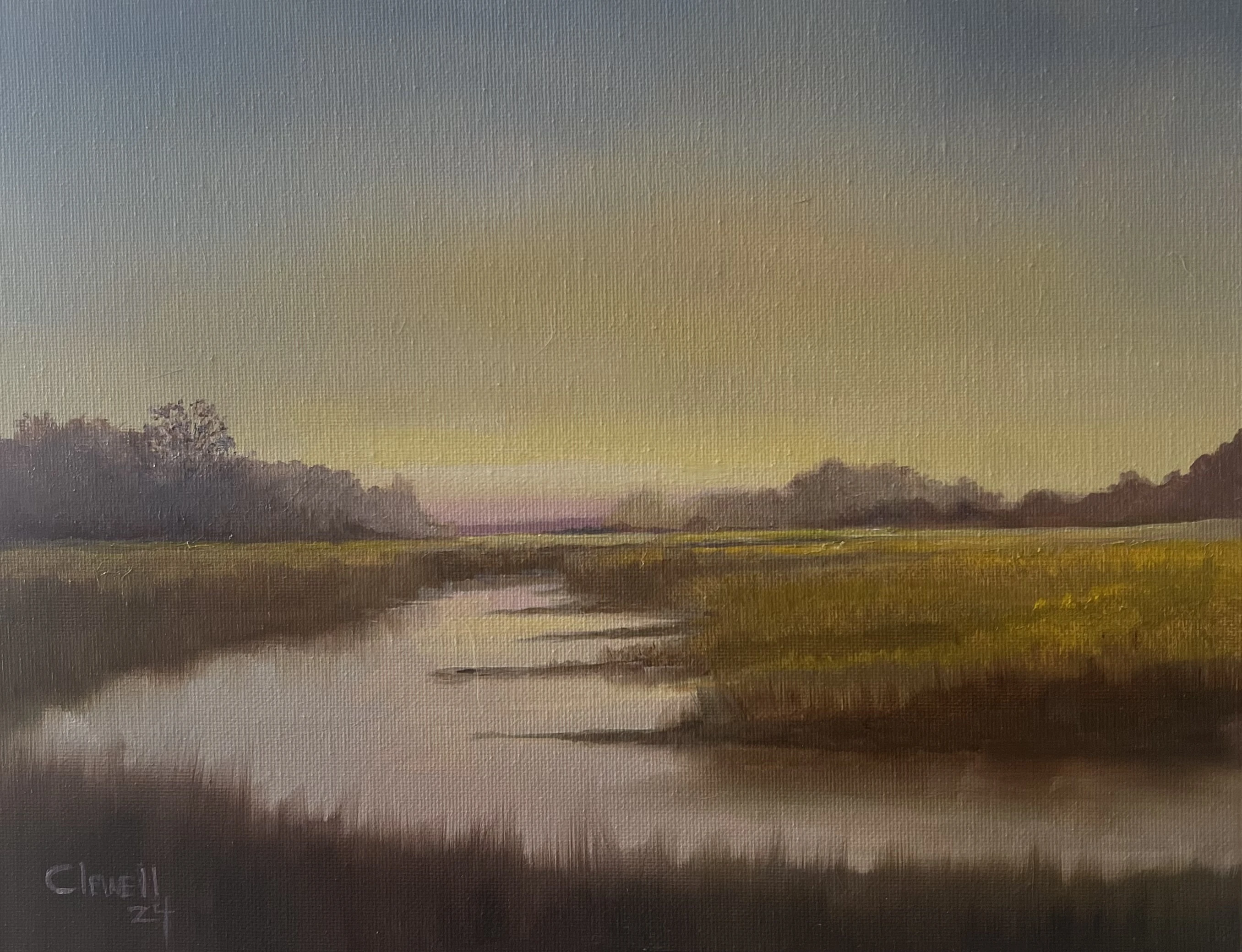 A quiet marsh waterway reflecting a muted evening sky